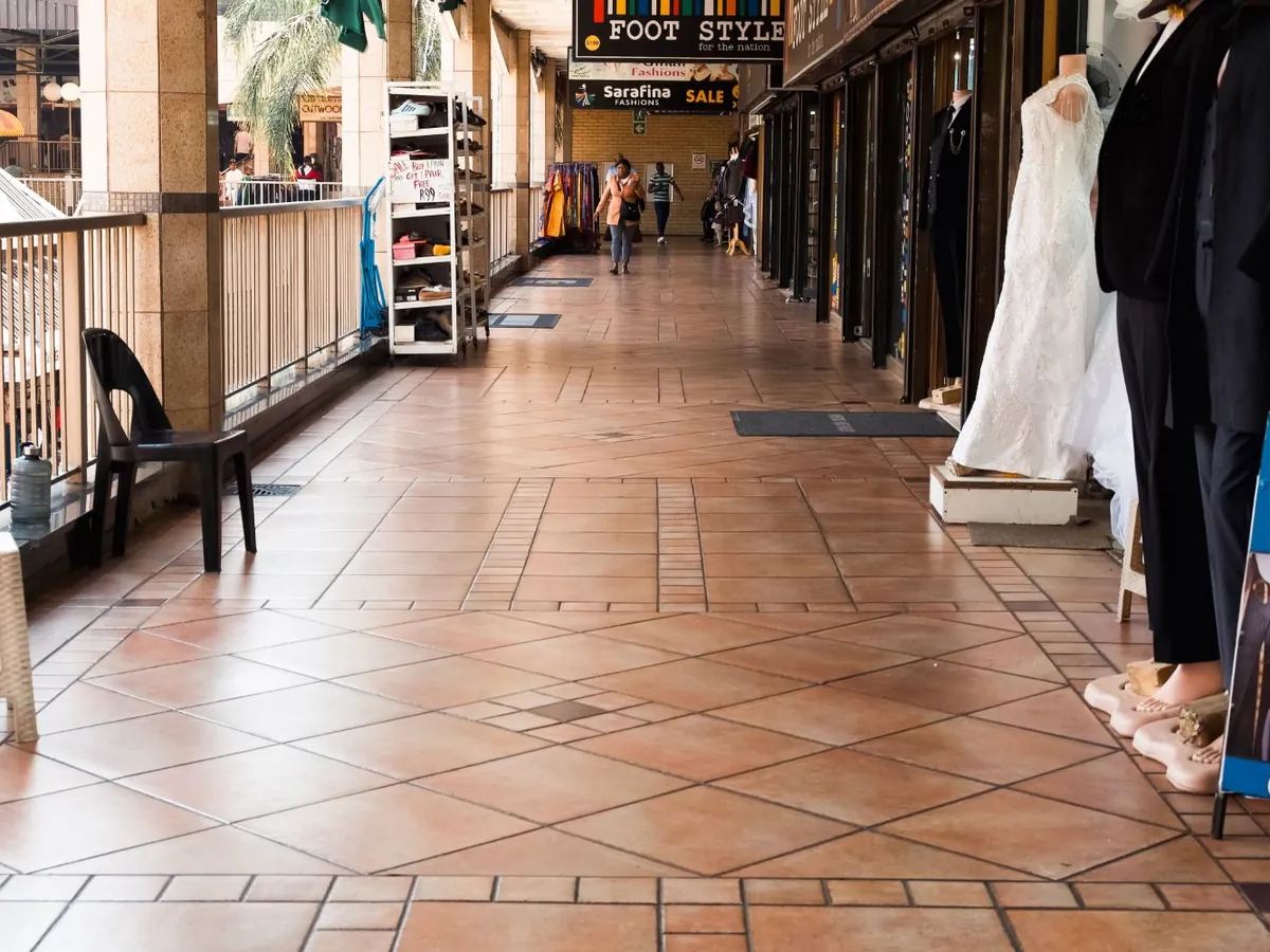 A walkway lined with bridal and evening wear on mannequins