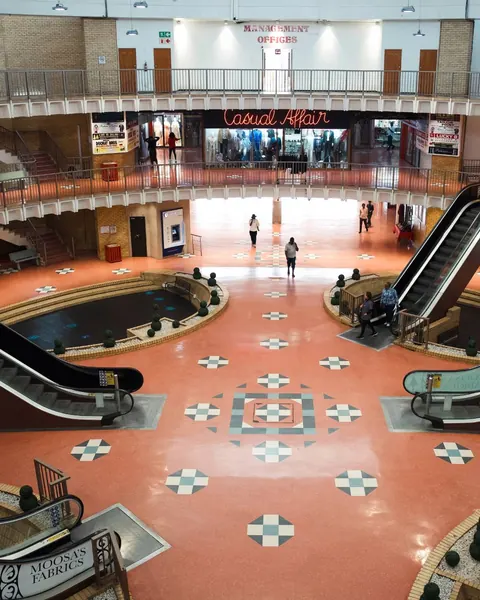 The circular Grand Bazaar atrium, with escalators and a patterned tiled floor