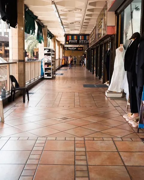A walkway lined with bridal and evening wear on mannequins