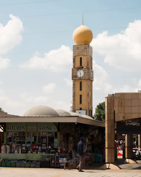 The golden-domed clock tower above the courtyard kiosks